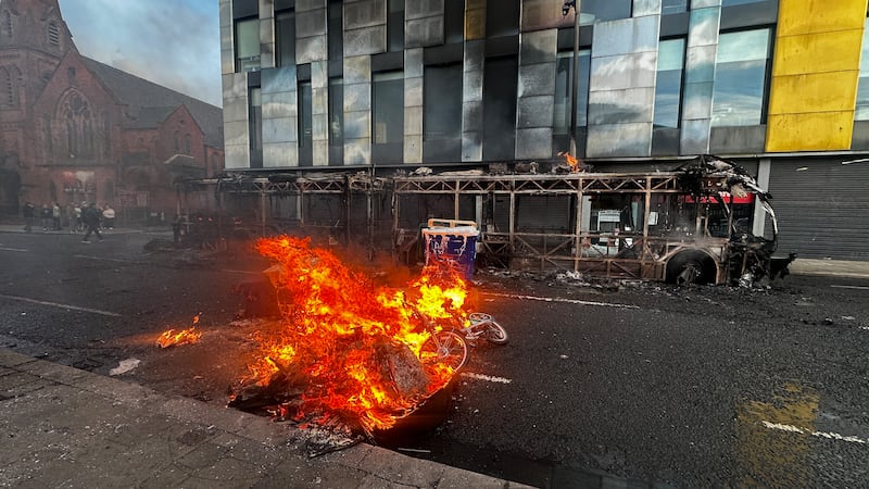 The remains of a Glider bus, set fire by protesters, on the Newtownards Road in east Belfast. Photograph: PA/PA Wire