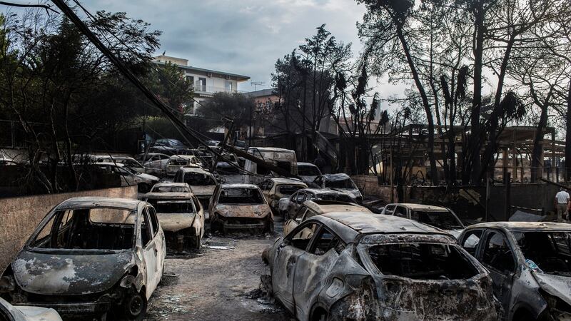 Burnt-out cars in Greece after flames had swept through. Photograph: Getty Images