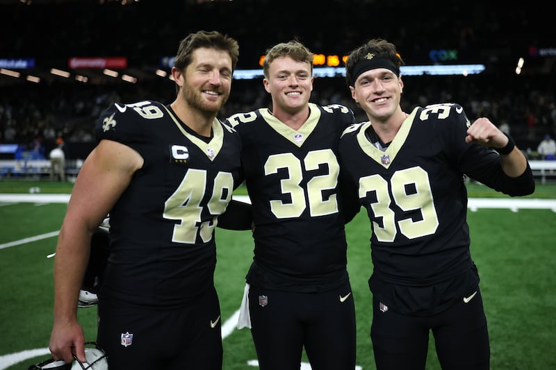 Charlie Smyth (right) celebrates with New Orleans Saints teammates Kai Kroeger (centre) and Zach Wood following victory against Carolina Panthers. Photograph: Chris Graythen/Getty Images