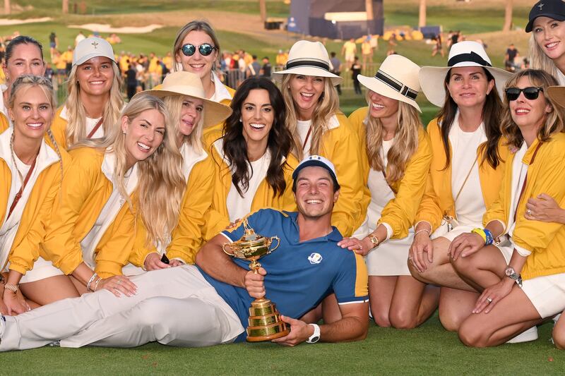 Viktor Hovland with the trophy and all of his European teammates' partners following the Ryder Cup in Rome in 2023. Photograph: Ross Kinnaird/Getty Images