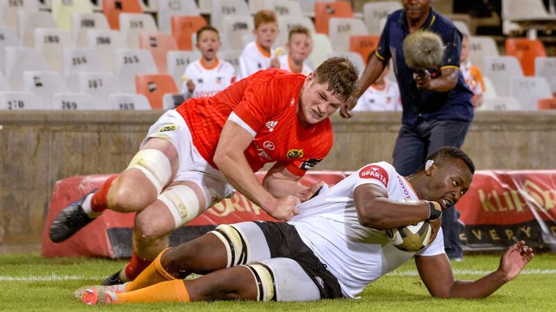 Junior Pokomela of the  Cheetahs scores a try despite the efforts of Munster’s Jack O’Donoghue  during the Guinness Pro 14 match  at the Toyota Stadium in Bloemfontein. Photograph: Frikkie Kapp/Inpho