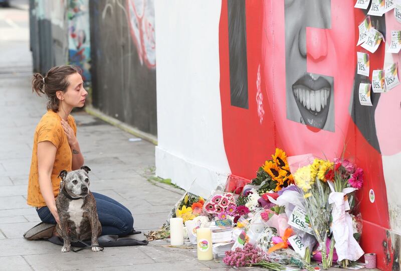 A woman sits in front of a mural of Savita Halappanavar in Dublin as votes are counted in the referendum on the 8th Amendment. Photograph: Niall Carson/PA Wire