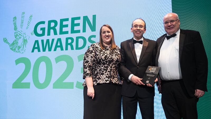 Ken Stockil, chief executive, 20FIFTY Partners, formerly known as Central Solutions, presents the Sustainable Energy Achievement Award to Nicola Woods and John Smith, An Post.