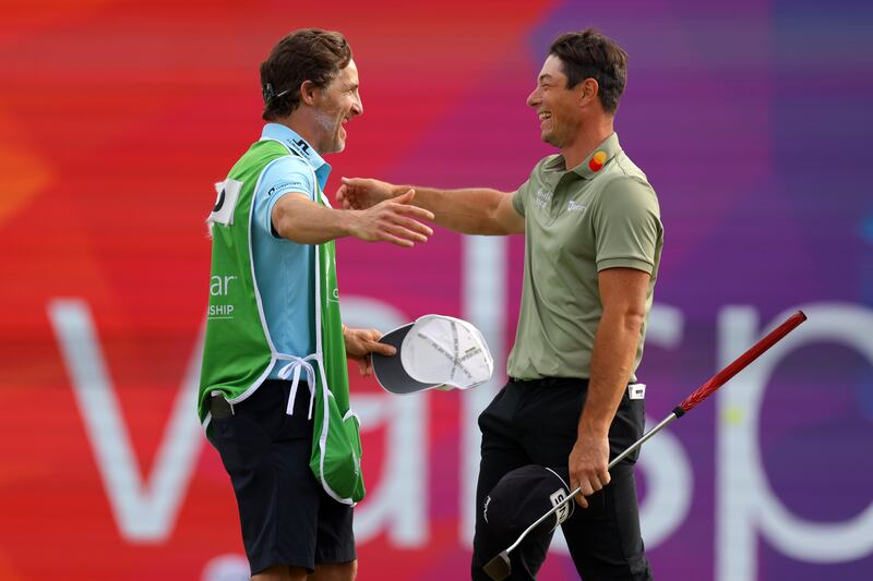 Viktor Hovland reacts with his caddie Shay Knight after putting on the 18th green during the final round of the Valspar Championship on Sunday. PhotograpH: Douglas P DeFelice/Getty Images