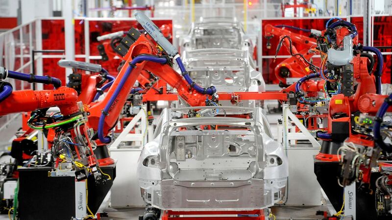 Robotic arms assemble Tesla’s Model S sedans at the company’s factory in Fremont, California.