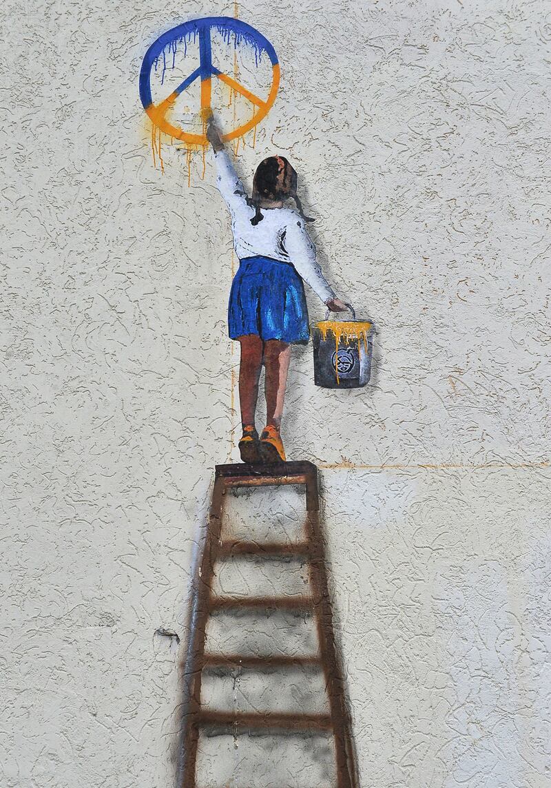 A graffiti signed by TVBOY on a wall of a building in the city of Bucha, near Kyiv, Ukraine, January 28th, 2023 amid the Russian invasion. TVBOY is the pseudonym of Salvatore Benintende, the 42-year-old Italian urban artist based in Barcelona. He was invited to Ukraine by the Cesvi foundation, one of the biggest humanitarian organisations in Italy, and visited the cities of Bucha and Irpin. Photograph: Andrii Nesterenko/EPA