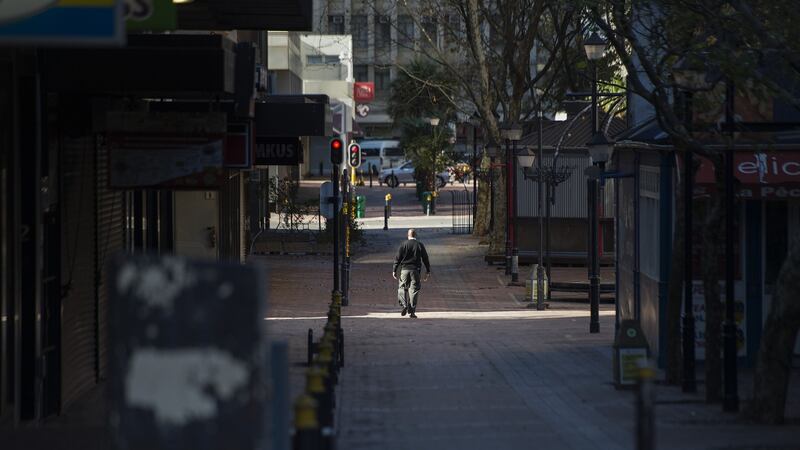 A security guard walks down a deserted St George’s Mall, in Cape Town. Photograph: Rodger Bosch/AFP via Getty