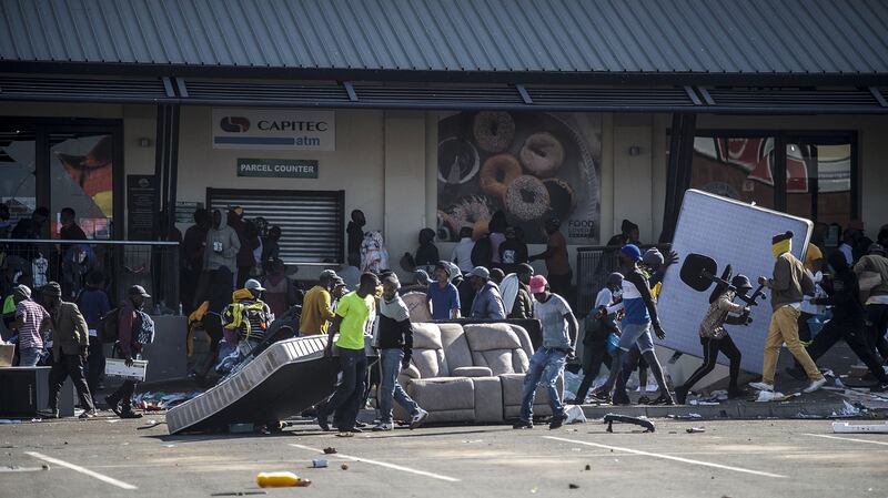 Rioters loot the Jabulani Mall in the Soweto district of Johannesburg on Monday, July 12th, 2021.  South Africa said it was deploying troops to two provinces, including Johannesburg, after unrest sparked by the jailing of ex-president Jacob Zuma led to six deaths and widespread looting. Photograph: Luca Sola/AFP/Getty