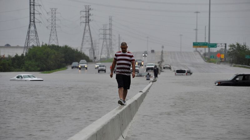 A stranded motorist escapes floodwaters in Texas on Sunday. Photograph:  Nick Oxford/Reuters