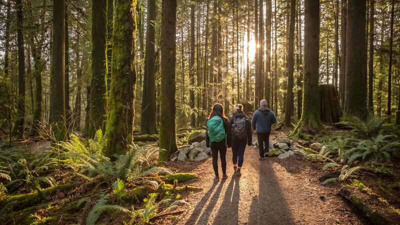 Mature father and Eurasian daughters hiking in Mt. Seymour Provincial Park, North Vancouver, British Columbia, Canada
