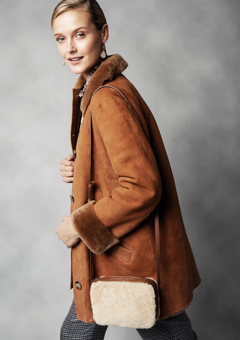 Shearling coat Pablo €1145, floral blouse Pablo €190, check trousers DMN €240, aquamarine and moonstone drop earrings Margaret Elizabeth at Loulerie €135, shearling bag Pablo €225.