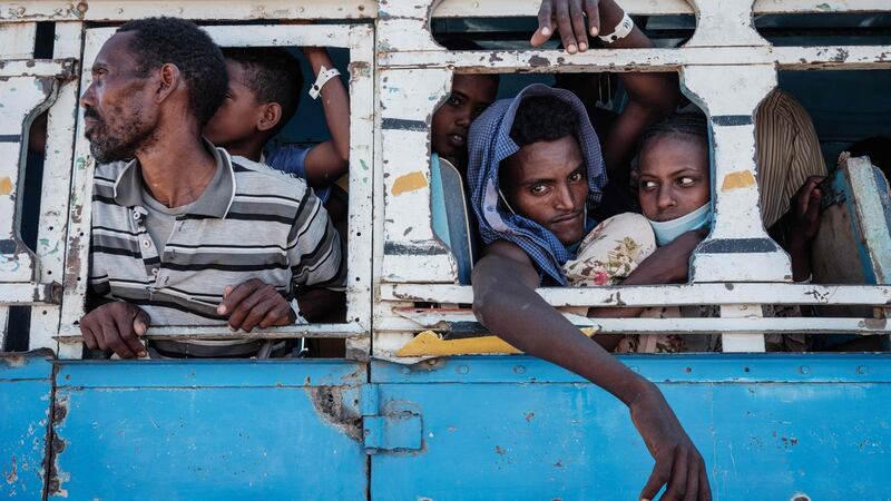 A newly married Ethiopian refugee couple, Luwam Hagos (right), 17, and Mekunnt Girmeay, 22, who fled the Ethiopia’s Tigray conflict, is transferred by bus from the Border Reception Centre to Um Raquba refugee camp. Photograph: Yasuyoshi Chiba/AFP via Getty Images
