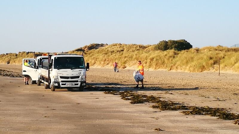 Council workers clean the beach at Portmarnock, Co Dublin, on July 5th. Photograph: Siobhán O’Connor/Twitter
