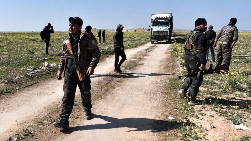 SDF fighters observe trucks loaded with displaced people near Baghouz town, northern Deir Ezzor province, eastern Syria, February 20th 2019. File photograph: Murtaja Lateef/EPA