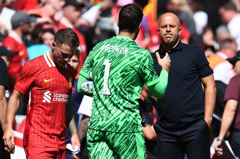 Liverpool's Dutch manager Arne Slot shakes hands with Alisson. Photograph: Peter Powell/AFP via Getty