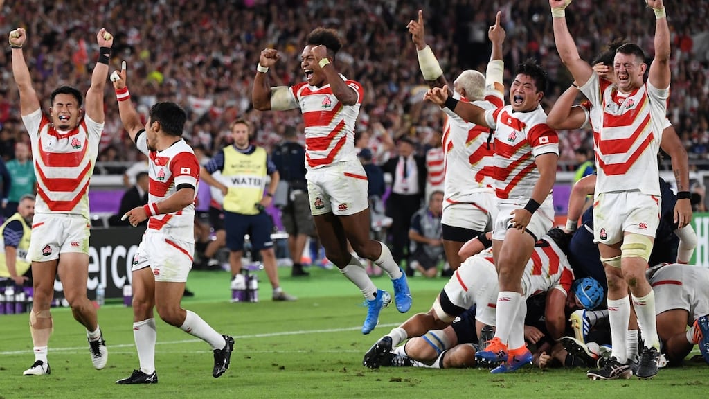 Japan’s players celebrate beating Scotland. Photo: William West/Getty Images