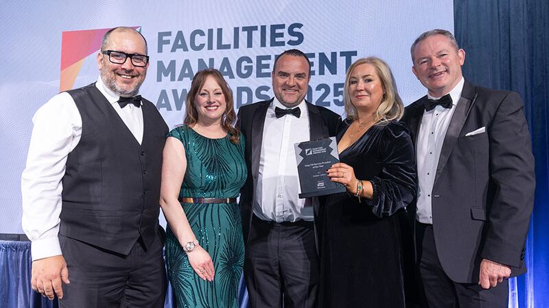 Liam Smith, sales director at Tork, an Essity Brand, presents the total FM service provider of the year award to the Sodexo Ireland team