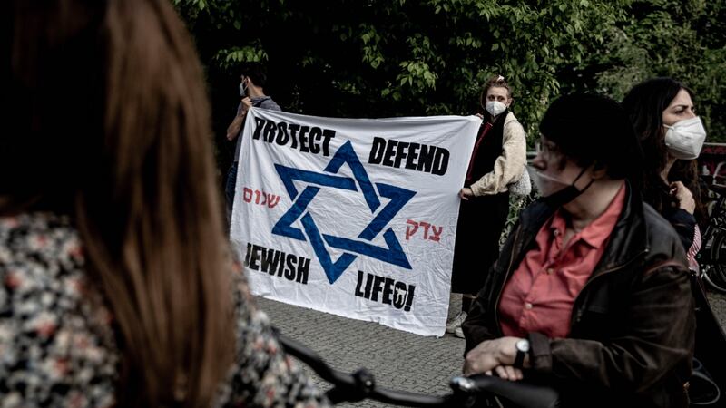 Participants of a vigil against anti-Semitism gather in front of the synagogue in Kreuzberg, Berlin on Sunday. Photograph: Filip Singer/EPA