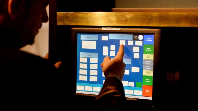 Darren Campbell, restaurant manager, working   the order management system