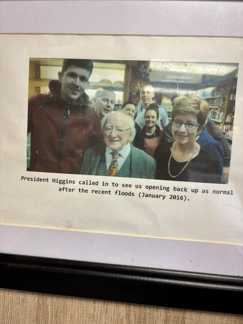 A photograph of staff from 2016 with the then President Michael D Higgins at The Bus Stop Shop in Enniscorthy. Photograph: James Cox.