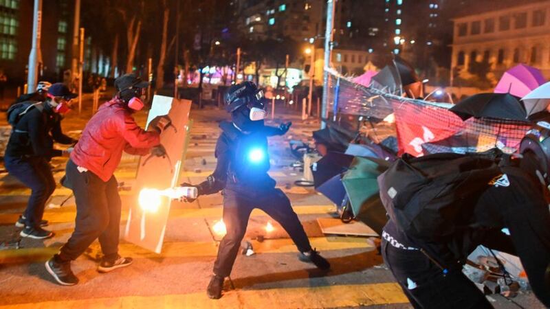 A protestor throws a petrol bomb during clashes with police outside the Polytechnic University of Hong Kong. Photograph: Ye Aung Thu/AFP/Getty