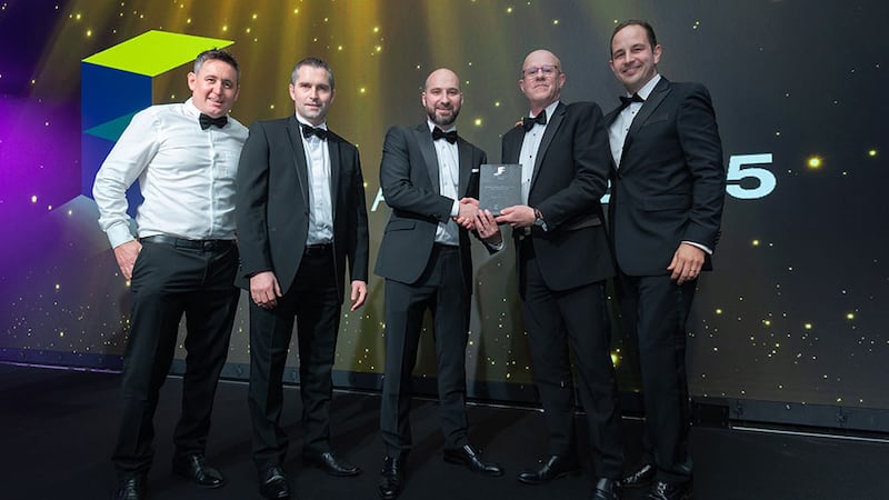 Matt Mohan, CEO at FKM Fit Out, presents the fit out project management firm of the year award to Turner & Townsend team