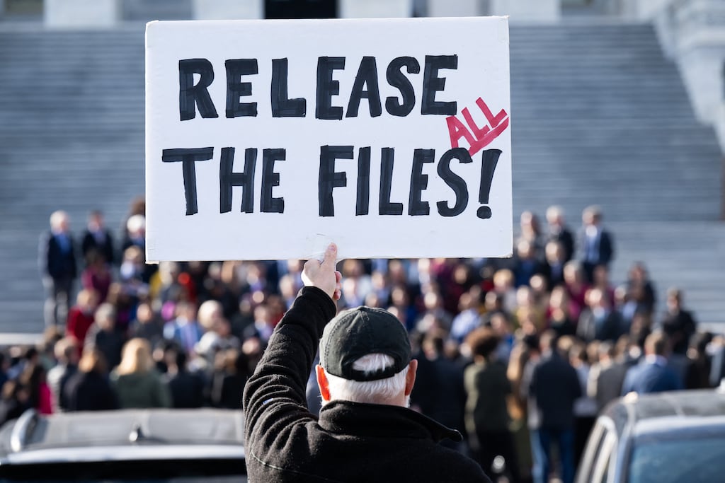A protester outside the US Capitol in Washington, DC, holds a sign related to the release of the Jeffrey Epstein case files. Photograph: SAUL LOEB/AFP via Getty Images