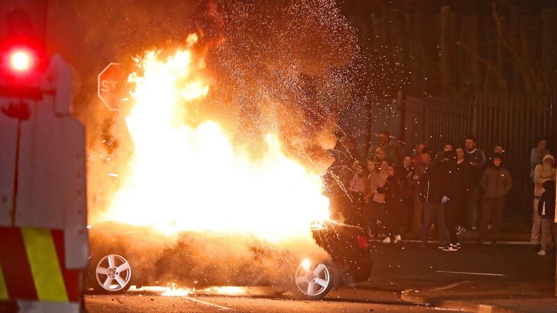 A hijacked car explodes after being set on fire during rioting in Derry last night. Photograph:  PA
