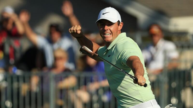 McIlroy celebrates after chipping in for birdie on the 15th. Photo: Mike Ehrmann/Getty Images