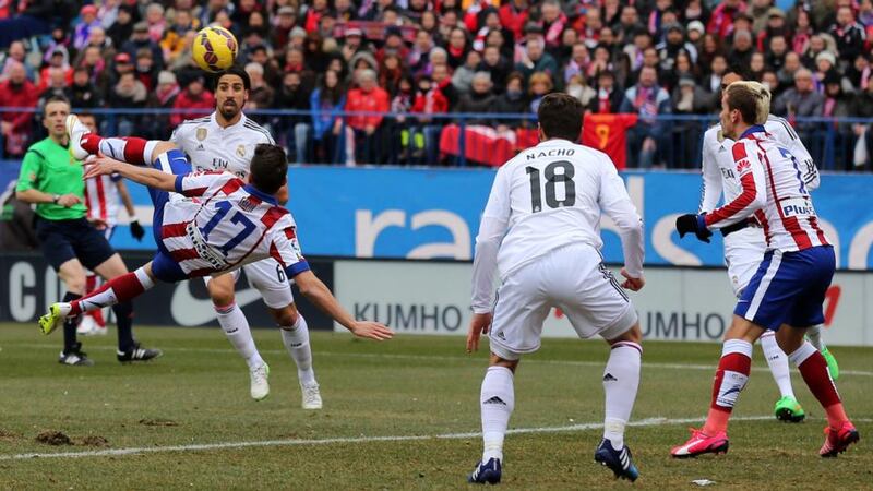 Atletico Madrid’s midfielder Saul Niguez (17) scores an overhead against Real Madrid  at the Vicente Calderon Stadium. Photograph: Cesar Mansocesar  / Getty Images