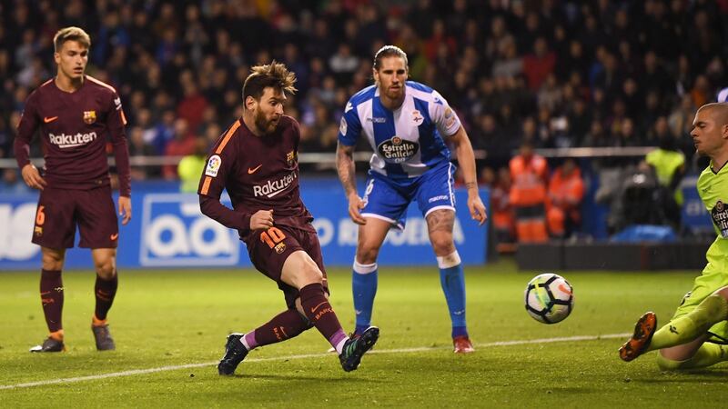 Messi scores his side’s third goal past Ruben of Deportivo La Coruna. Photo: David Ramos/Getty Images