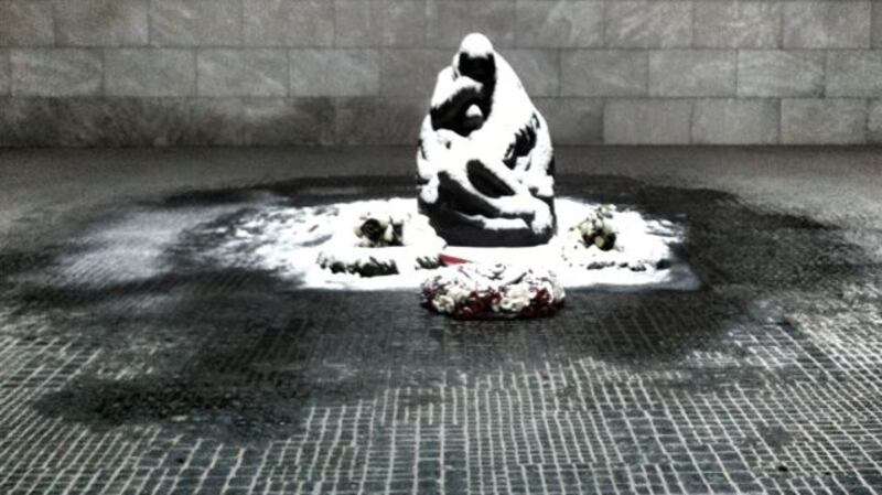 The pietà-style figure is an enlargement of a sculpture by Käthe Kollwitz, and is located under an unglazed skylight where it is exposed to the rain and snow of the Berlin winter
