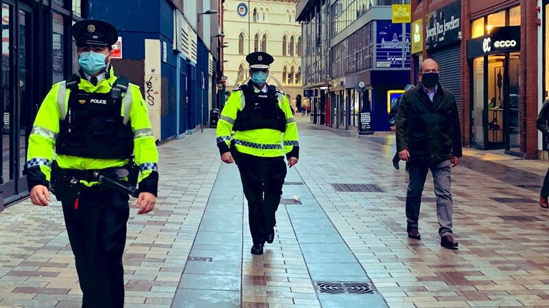 PSNI chief constable Simon Byrne (centre) and chief medical officer Dr Michael McBride (right)  accompanied a routine patrol in Belfast city centre to ensure compliance with coronavirus regulations. Photograph: Chief constable Simon Byrne/PA Wire