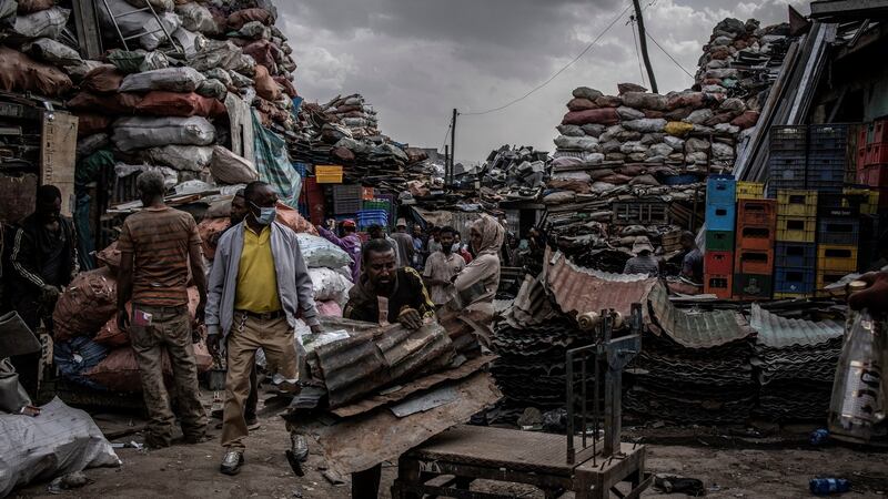 A man weights sheet metal at a recycling depot in  Addis Ababa. Photograph: Finbarr O’Reilly/New York Times
