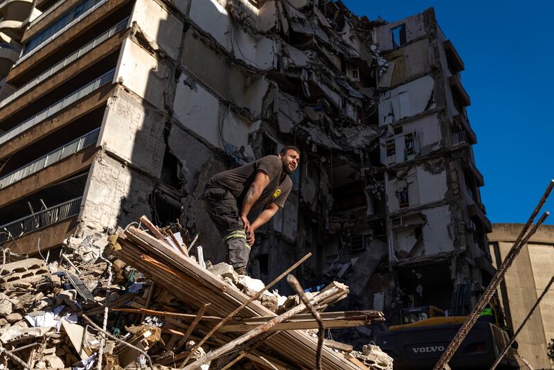 Rescue workers search the site of an Israeli air strike in the Tallet el Khayat area of Beirut, Lebanon, on Thursday.