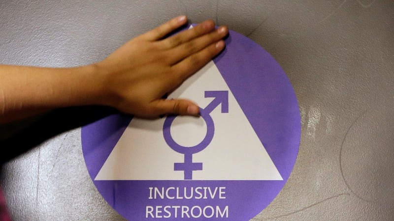 A  file photo showing a sticker placed on the door at the ceremonial opening of a gender neutral bathroom at Nathan Hale High School in Seattle. Photograph: AP