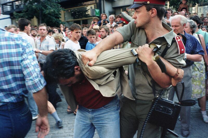 A protester is grabbed by a policeman during a protest on August 21st, 1989, on Prague's Wenceslas Square to commemorate the 21st anniversary of the 1968 Prague Spring. Photograph: Patrick Hertzog/AFP via Getty          