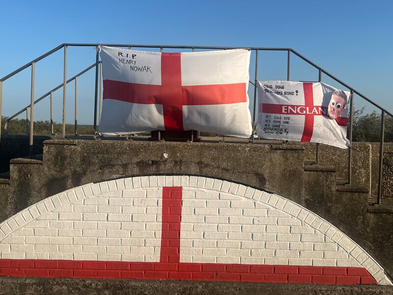 Flags in Jaywick pay tribute to Henry Nowak and taunt prime minister Keir Starmer. Photograph: Mark Paul