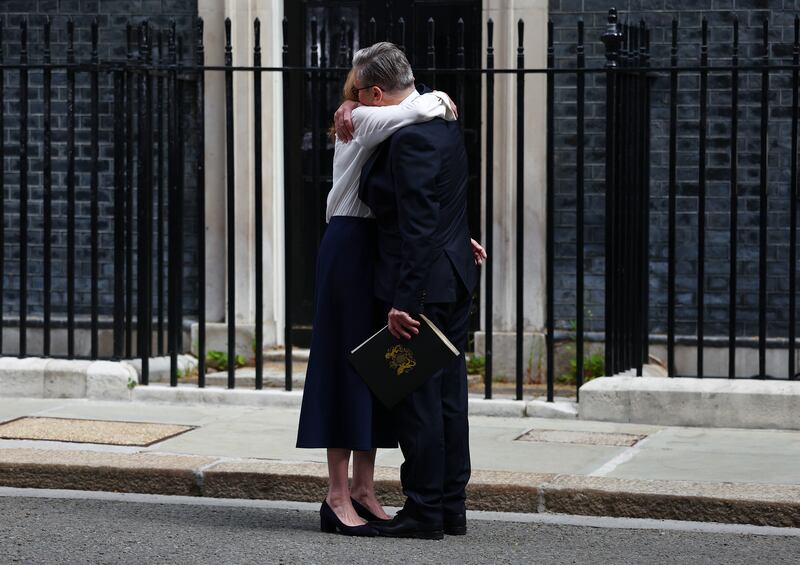 Keir Starmer hugs his wife Victoria after announcing his resignation as UK prime minister. Photograph: Peter Nicholls/Getty Images