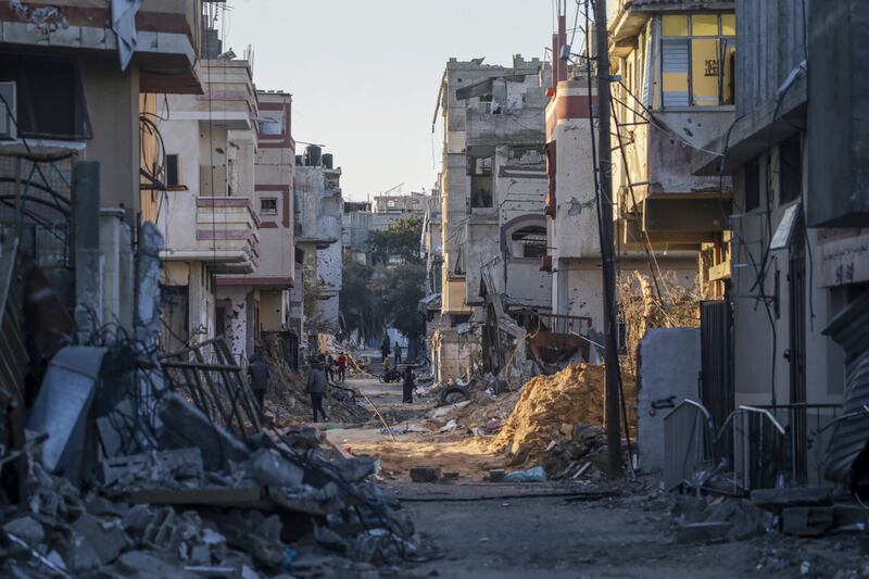 Palestinians walk among the rubble of destroyed houses in Al Bureij refugee camp, Gaza Strip, on Wednesday. Photograph: Mohammed Saber