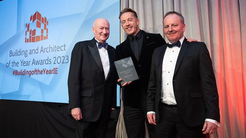 Aaron O'Grady, founder, Vision Creative Studios, presents the architectural practice of the year award to Paul O'Brien and Finghin Curraoin, Henry J Lyons