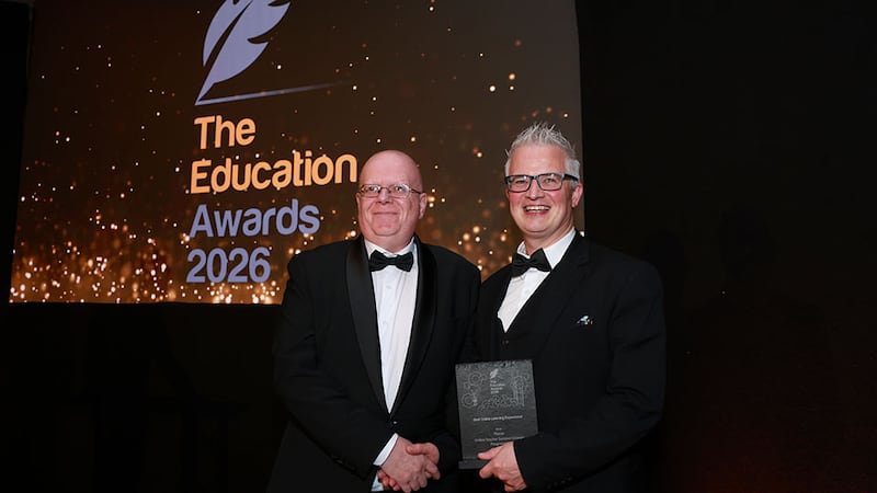 Martin O'Connell, awards judge, presents the best online learning experience award to Tomas Finneran, Flúirse