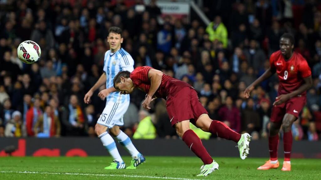 Portugal’s Raphael Guerreiro stoops to head in his side’s late winner against Argentina at Old Trafford