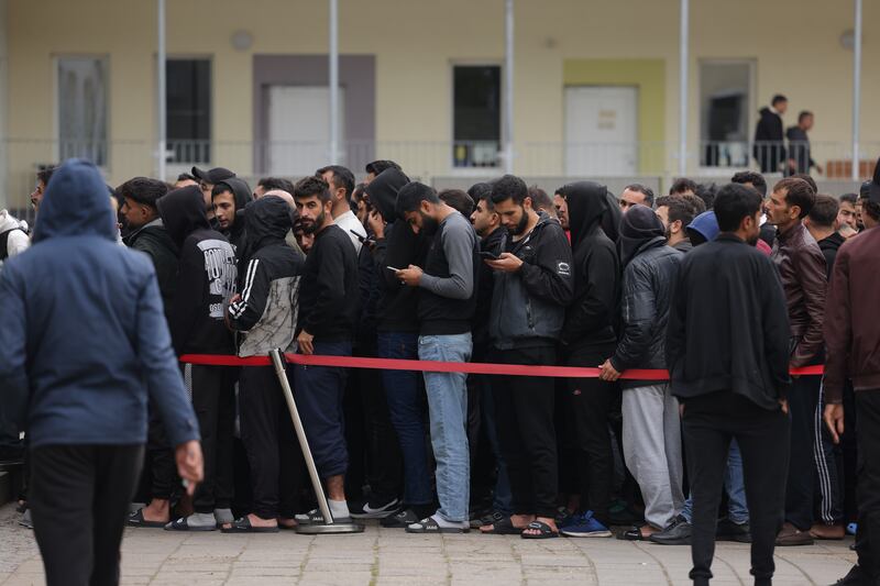 Men, mostly from Syria, queuing at a reception facility for migrants and refugees in Eisenhuettenstadt, Germany, in 2023. Photograph: Sean Gallup/Getty Images