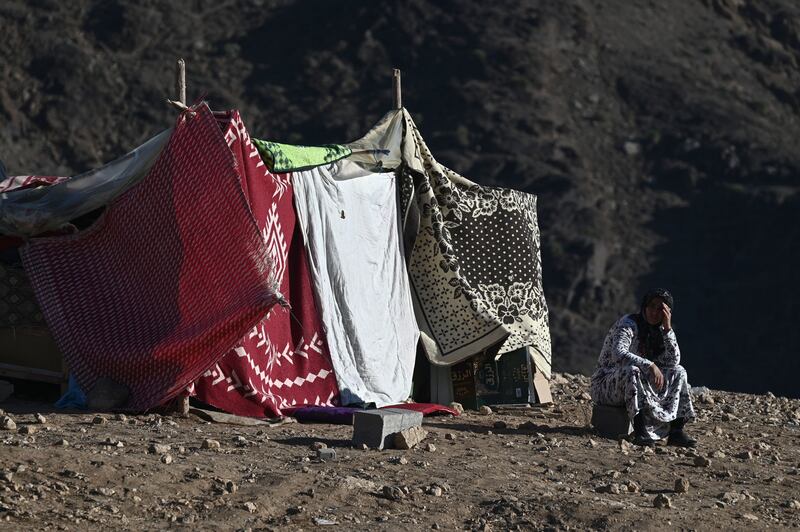 A woman sits outside her makeshift shelter in the mountain village of Moulay Brahim, after Friday's earthquake. Photograph: Philippe Lopez/AFP via Getty Images