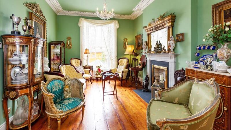 The two interconnecting reception rooms at hall level at 22 Howth Road are packed with period furniture.