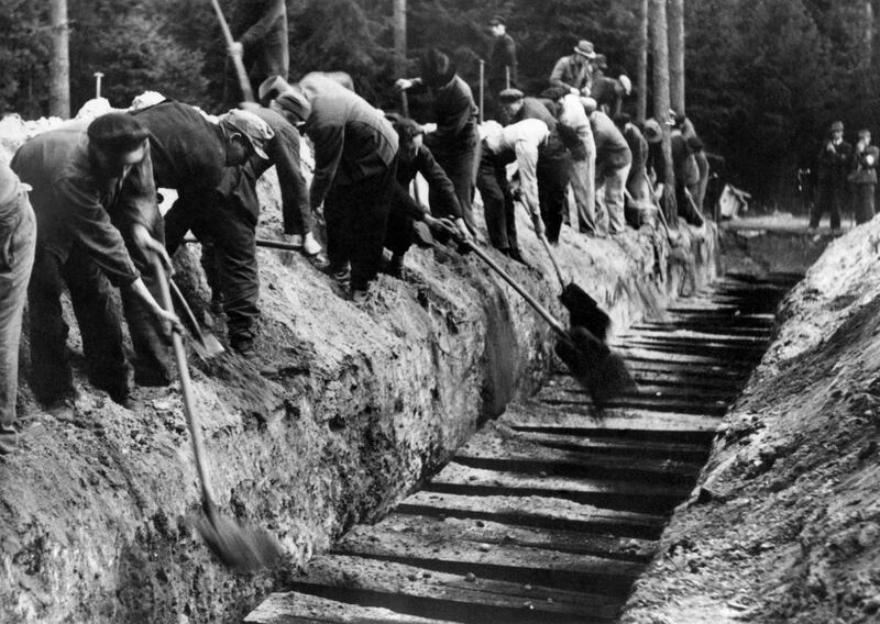 Nazi officials forced by British authorities to exhume and then bury properly the bodies of 100 political deportees after the liberation of the Bergen-Belsen camp in 1945. Photograph: AFP via Getty Images
