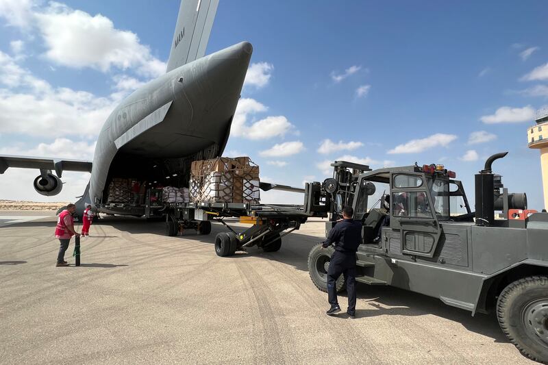 Volunteers from Qatar and Egypt's Red Crescent humanitarian organisations unload aid destined for the Gaza Strip at Egypt's el-Arish airport in the north Sinai peninsula on Sunday. Photograph: Callum Paton/AFP/Getty 