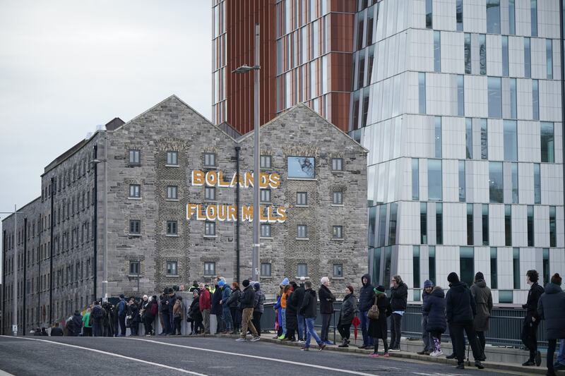 Crowds line the streets by Grand Canal Dock as they wait for the funeral procession of Shane MacGowan to make its way through the streets of Dublin. Photograph: Niall Carson/PA Wire