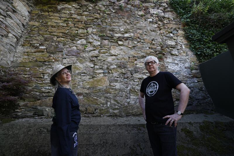 Colleen and André Tschan at the medieval wall at the end of their garden in Abbey Street, Wexford.  Photograph: Nick Bradshaw